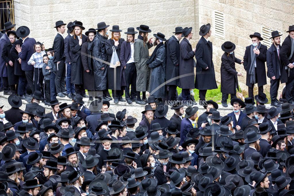 Ariel Schalit File - In this Sunday, Jan. 31, 2021 file photo, thousands of ultra-Orthodox Jews participate in funeral for prominent rabbi Meshulam Soloveitchik, in Jerusalem. The mass ceremony took place despite the country's health regulations banning large public gatherings, during a nationwide lockdown to curb the spread of the coronavirus. (AP Photo/Ariel Schalit, File)