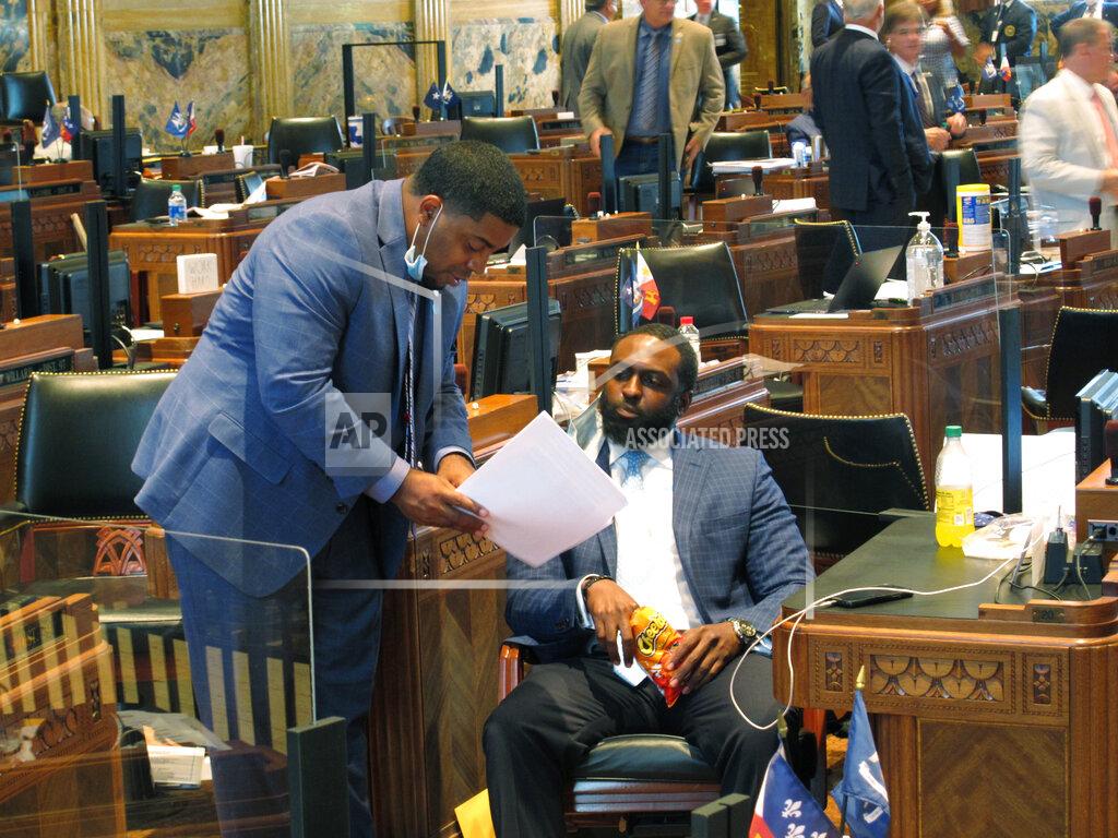 Melinda Deslatte Rep. Dustin Miller, D-Opelousas, left, speaks with Rep. Ted James, D-Baton Rouge, on the House floor as the Louisiana Legislature reached the final hours of its legislative session, on Monday, June 29, 2020, in Baton Rouge, La. (AP Photo/Melinda Deslatte)
