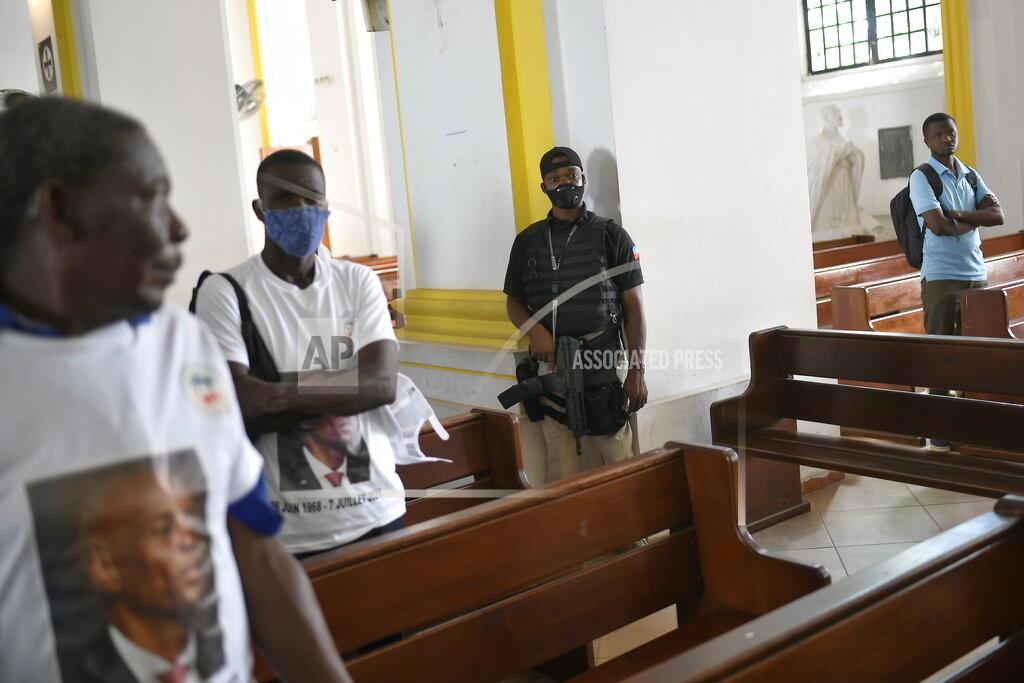 Matias Delacroix The city mayor's security guard stands by during a memorial service for slain Haitian President Jovenel Moïse in the Cathedral of Cap-Haitien, Haiti, Thursday, July 22, 2021. Moïse was killed in his home on July 7. (AP Photo/Matias Delacroix)
