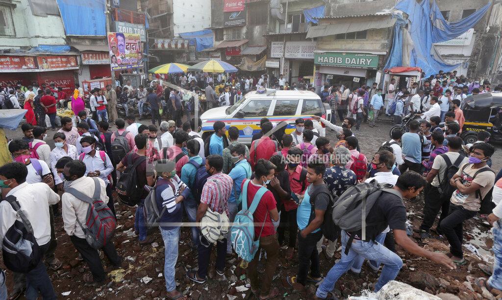 Rafiq Maqbool A police vehicle patrols as migrant workers wait for work in Mumbai, India, Monday, Nov. 23, 2020. India has more than 9 million cases of coronavirus, second behind the United States. (AP Photo/Rafiq Maqbool)