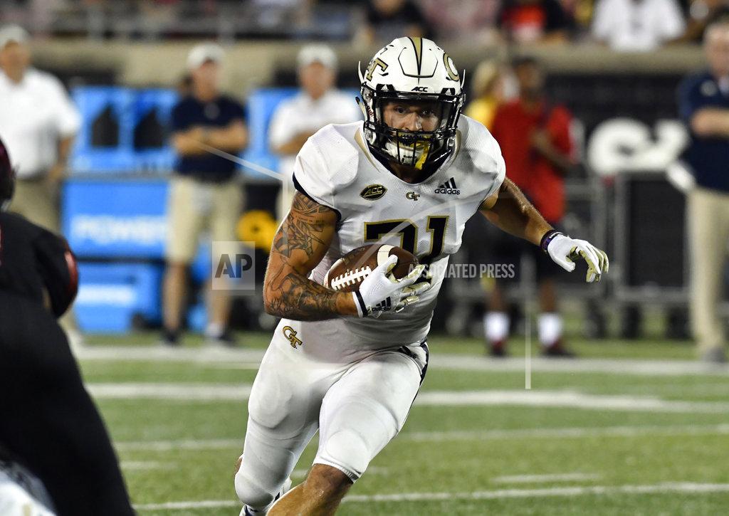 Timothy D. Easley Georgia Tech running back Nathan Cottrell (31) runs through an opening in the Louisville defensive line during the second half of an NCAA college football game, Friday, Oct. 5, 2018, in Louisville, Ky. Georgia Tech won 66-31. (AP Photo/Timothy D. Easley)