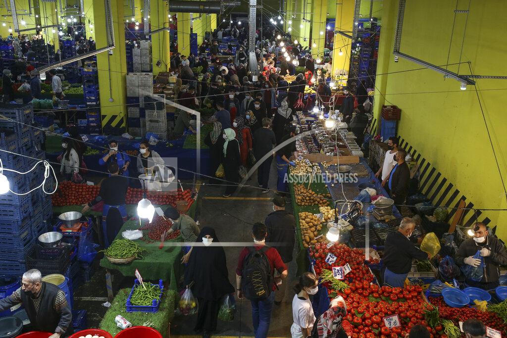 Emrah Gurel People shop at the local market in Istanbul, Thursday, April 29, 2021, a few hours before the start of the latest lockdown to help protect from the spread of the coronavirus. People stocked up on groceries, shoppers filled markets and many left cities for their hometowns or the southern coast as Turkey's strictest COVID-19 lockdown yet came into effect late Thursday. President Recep Tayyip Erdogan imposed a "full lockdown" until May 17 amid soaring COVID-19 infections and deaths. Turkey now ranks among the world's worst-hit countries and it's the first time that it is imposing a nearly three-week lockdown for the whole of the country. (AP Photo/Emrah Gurel)