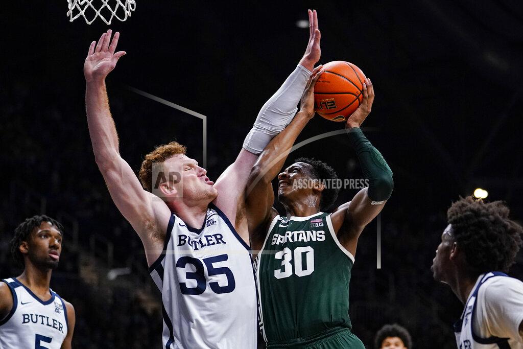 Michael Conroy Michigan State forward Marcus Bingham Jr. (30) shoots over Butler forward John-Michael Mulloy (35) in the second half of an NCAA college basketball game in Indianapolis, Wednesday, Nov. 17, 2021. Michigan State defeated Butler 73-52. (AP Photo/Michael Conroy)