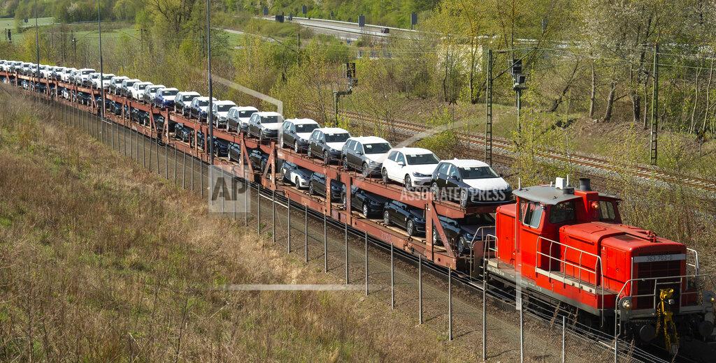 Jens Meyer A train transports new Volkswagen cars during the production restart of the plant of the German manufacturer Volkswagen AG (VW) in Zwickau, Germany, Thursday, April 23, 2020. Volkswagen starts with step-by-step resumption of production. The car company are completely converting the plant in Zwickau from 100 percent combustion engine to 100 percent electric. (AP Photo/Jens Meyer)