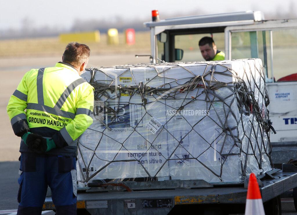 Darko Vojinovic Workers unload boxes of the Astra Zeneca vaccine at the Belgrade Airport, Serbia, Sunday, Feb. 21, 2021. 150,000 doses of Astra Zeneca vaccines were delivered to Serbia. (AP Photo/Darko Vojinovic)