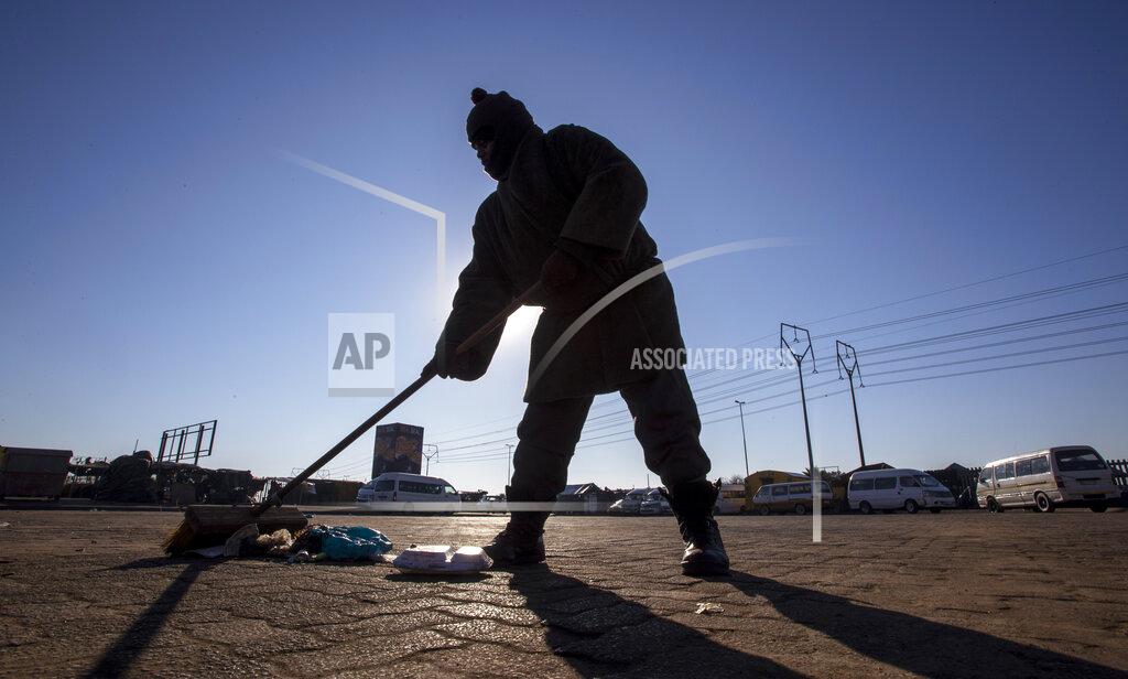 Themba Hadebe A worker sweeps the floor at a taxi rank in Katlehong, South Africa, Monday, June 22, 2020, as taxi drivers affiliated to the SA National Taxi Council (Santaco) protested against what it believes to be insufficient government relief offered to the industry. South Africa’s largest city, Johannesburg, has been hit by a strike by mini-bus taxis, preventing many thousands of people from getting to work on Monday, as the country reopens its economy even as cases of COVID-19 are increasing. (AP Photo/Themba Hadebe)