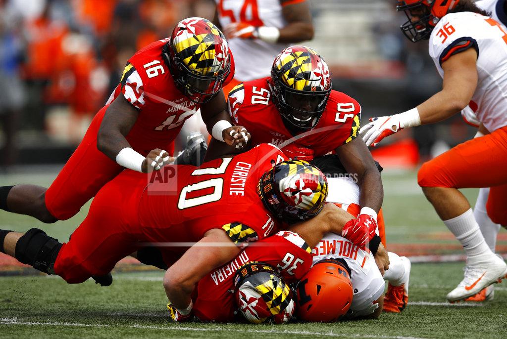 Patrick Semansky A group of Maryland defenders tackle Illinois wide receiver Jordan Holmes as he rushes the ball in the first half of an NCAA college football game, Saturday, Oct. 27, 2018, in College Park, Md. (AP Photo/Patrick Semansky)