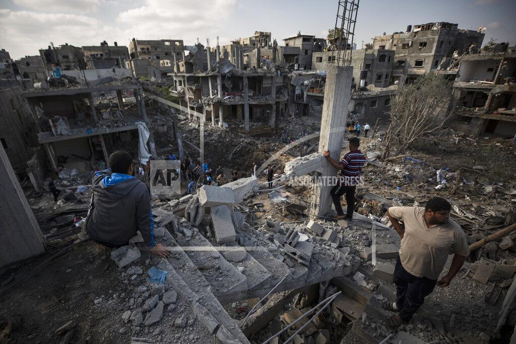 Khalil Hamra Palestinians inspect their destroyed houses following overnight Israeli airstrikes in town of Beit Hanoun, northern Gaza Strip, Friday, May 14, 2021. (AP Photo/Khalil Hamra)