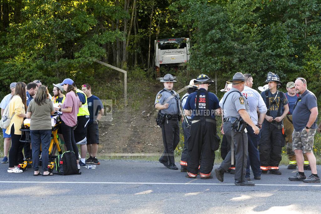 Jacqueline Dormer First responders work the scene after a Premiere #1 Limousine bus crashed into a wooded area off I-81 in Frailey Township, Pa., on Sunday, Sept. 19, 2021. The bus was traveling on I-81 south and came off the Hegins exit ramp, crossing through the divider on Rt. 25 and crashing into a wooded area off Rt. 25 where it came to a stop. (Jacqueline Dormer/Republican-Herald via AP)