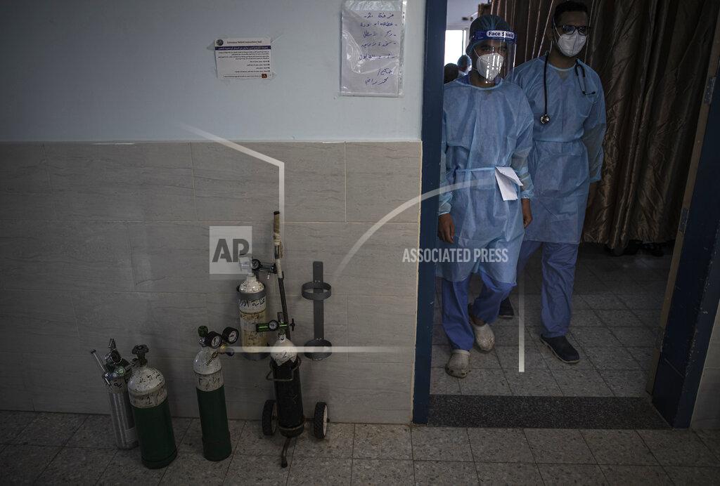 Khalil Hamra Palestinian doctors wearing protective medical gear walk out of the intensive care unit of the Gaza European Hospital, in the Gaza Strip, Thursday, May 6, 2021. (AP Photo/Khalil Hamra)