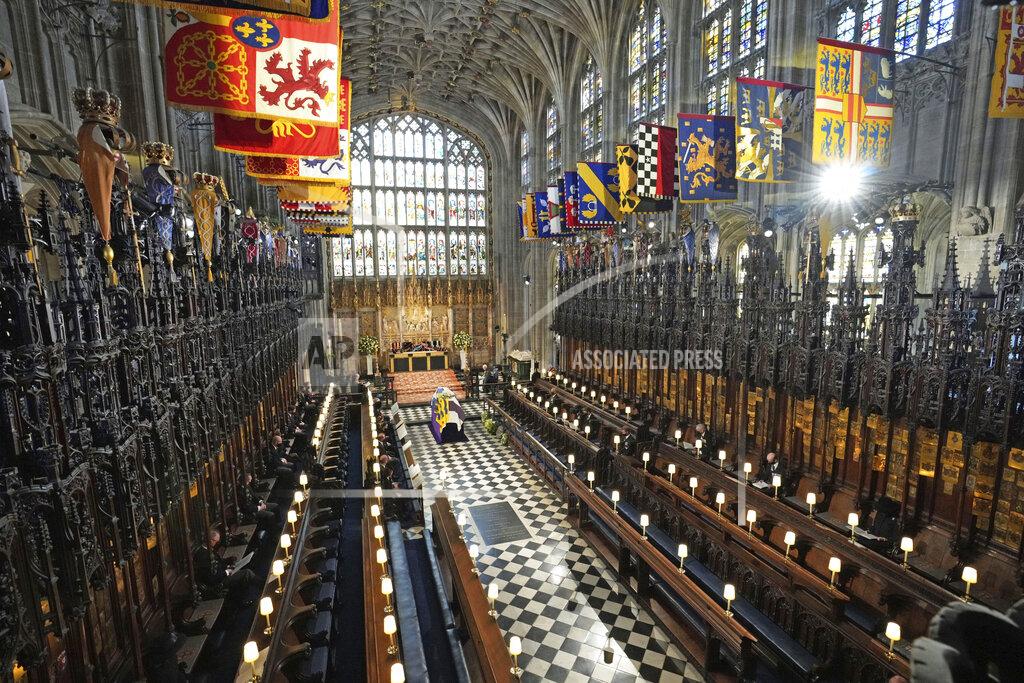 Yui Mok The royal family members and guests sits socially distanced as the flag draped coffin sits on a bier, centre, during the funeral for Britain Prince Philip inside St George's Chapel in Windsor Castle, Windsor, England, Saturday April 17, 2021. Prince Philip died April 9 at the age of 99 after 73 years of marriage to Britain's Queen Elizabeth II. (Yui Mok/Pool via AP)
