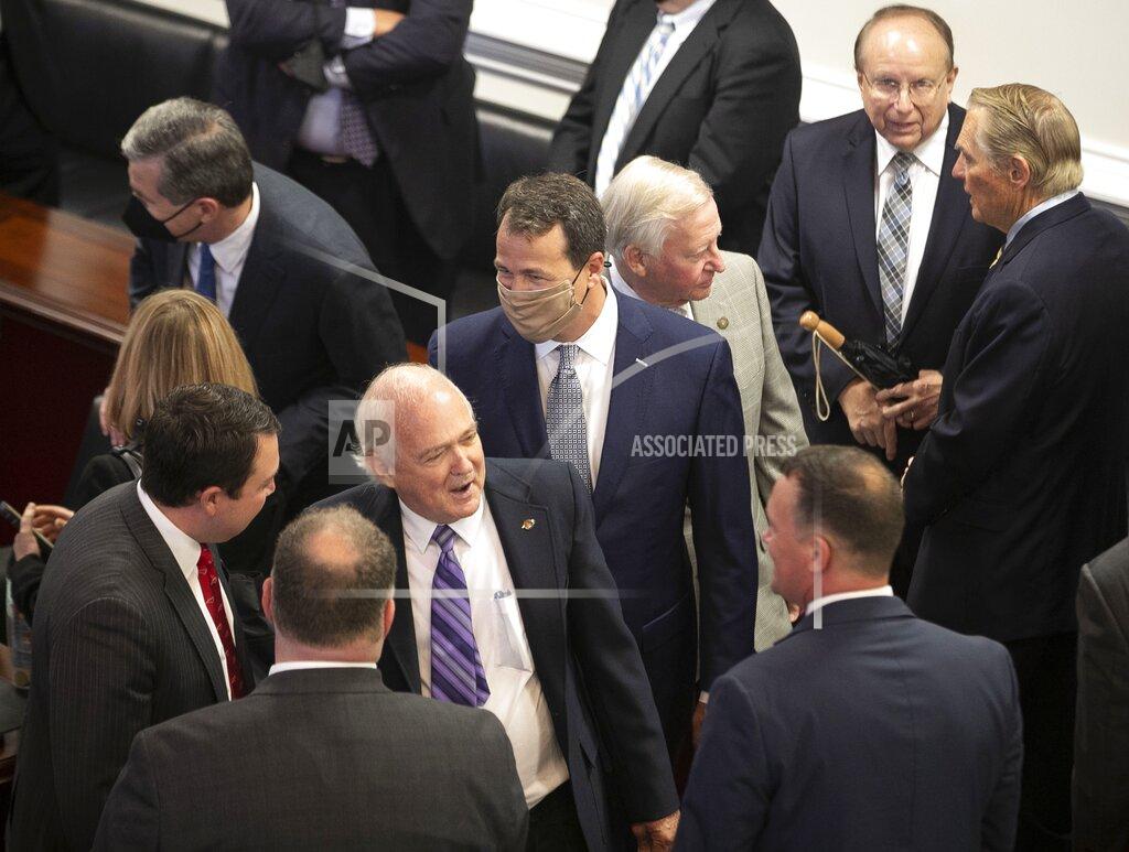 Robert Willett Former State Senator Cal Cunningham of Lexington, N.C., center, mingles with lawmakers prior to the unveiling of a portrait of former Senate President Pro Tempore Marc Basnight on Tuesday, September 21, 2021 at the General Assembly in Raleigh, N.C. (Robert Willett/The News & Observer via AP)