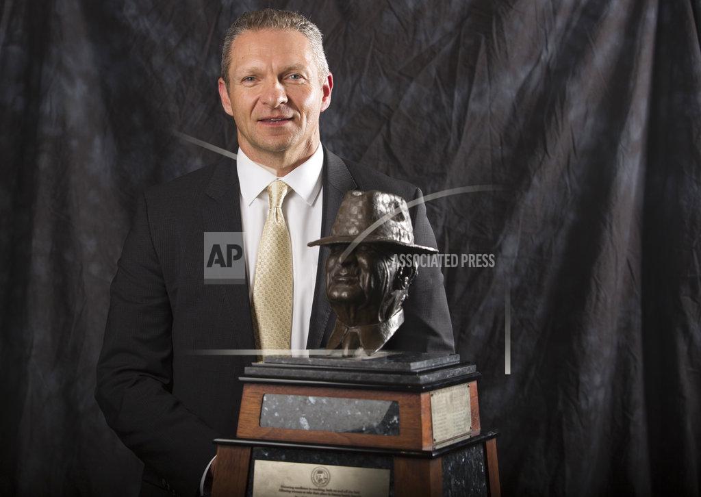 Yi-Chin Lee Army coach Jeff Monken poses for a photograph with the Paul "Bear" Bryant Coach of the Year Award, before the ceremony Wednesday, Jan. 9, 2019, in Houston. (Yi-Chin Lee/Houston Chronicle via AP)