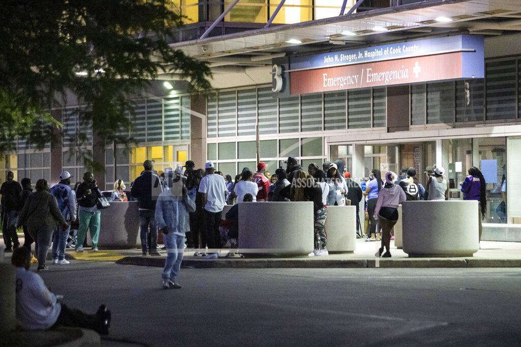 Ashlee Rezin Garcia Hundreds of mourners gather in the parking lot of Stroger Hospital after a 40-year-old man was shot to death in the 700 block of North Spaulding Avenue on Memorial Day, Monday night, May 31, 2021, in Chicago. (Ashlee Rezin Garcia/Chicago Sun-Times via AP)