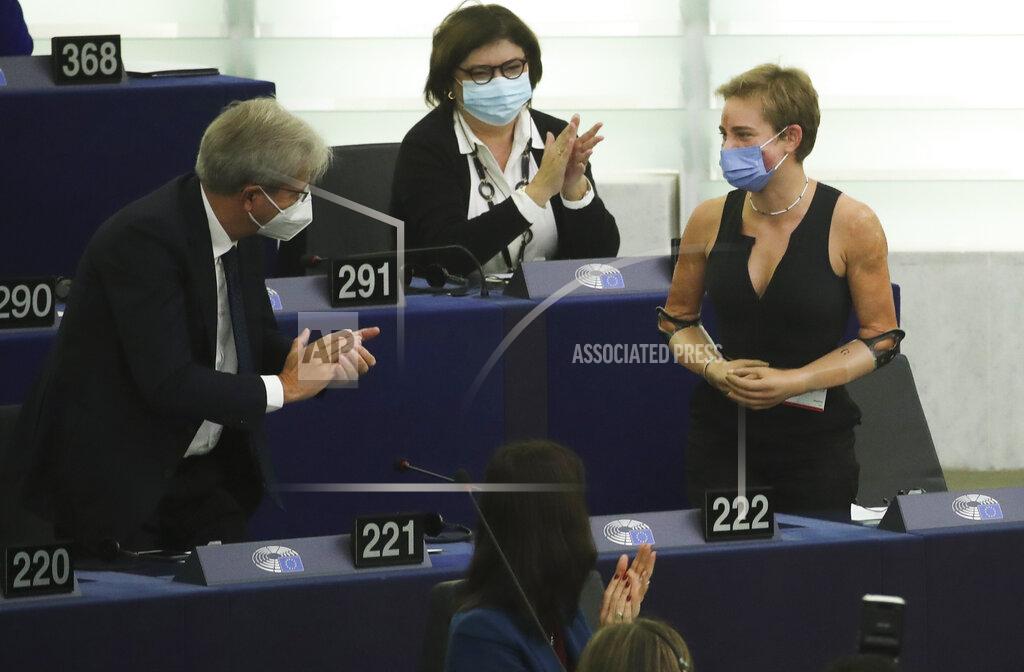 Yves Herman European Commissioner for Economy Paolo Gentiloni, left, speaks with Tokyo 2020 Paralympic gold medallist Beatrice Vio, right, at the European Parliament in Strasbourg, France, Wednesday, Sept. 15, 2021. The European Union announced Wednesday it is committing 200 million more coronavirus vaccine doses to Africa to help curb the COVID-19 pandemic on a global scale. (Yves Herman, Pool via AP)