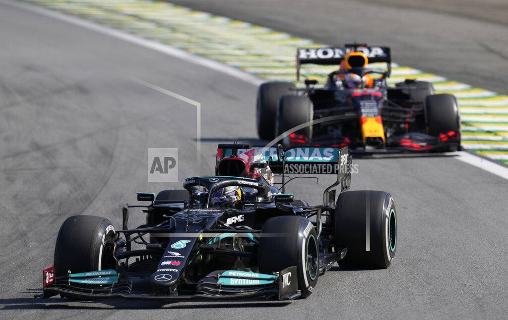 Andre Penner Mercedes' Lewis Hamilton, front, steers his car followed by Red Bull's Max Verstappen , during the Brazilian Formula One Grand Prix at the Interlagos race track in Sao Paulo, Brazil, Sunday, Nov. 14, 2021. (AP Photo/Andre Penner)