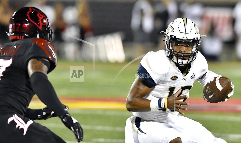 Timothy D. Easley Georgia Tech quarterback TaQuon Marshall (16) attempts to avoid the pressure of Louisville linebacker Dorian Etheridge (17) during the first half of an NCAA college football game, Friday, Oct. 5, 2018, in Louisville, Ky. (AP Photo/Timothy D. Easley)