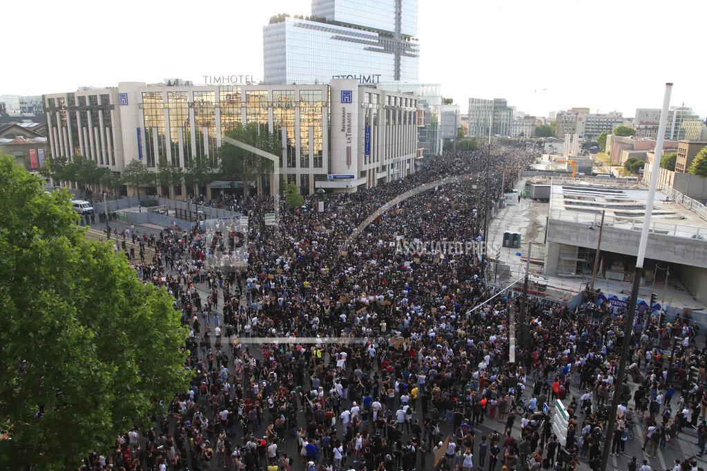 Michel Euler Protesters gather Tuesday, June 2, 2020 in Paris. Thousands of people defied a police ban and converged on the main Paris courthouse for a demonstration to show solidarity with U.S. protesters and denounce the death of a black man in French police custody. The demonstration was organized to honor Frenchman Adama Traore, who died shortly after his arrest in 2016, and in solidarity with Americans demonstrating against George Floyd's death. (AP Photo/Michel Euler)