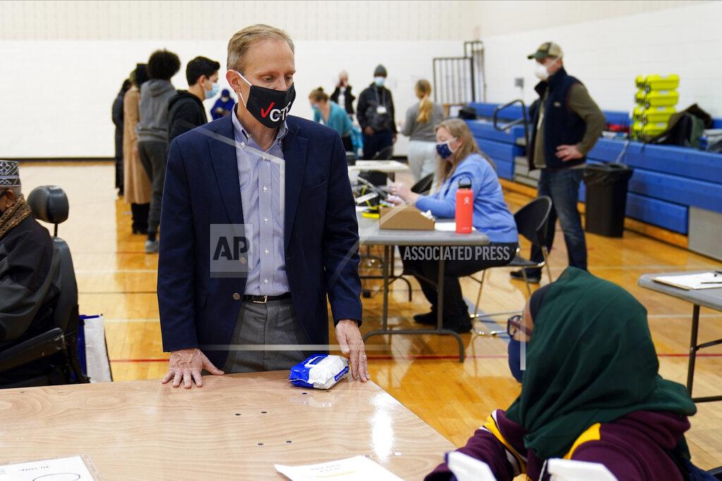 Jim Mone Minnesota Secretary of State Steve Simon visits with poll workers as he toured the Brian Coyle Center, Election Day Tuesday, Nov. 3, 2020, in Minneapolis. (AP Photo/Jim Mone)