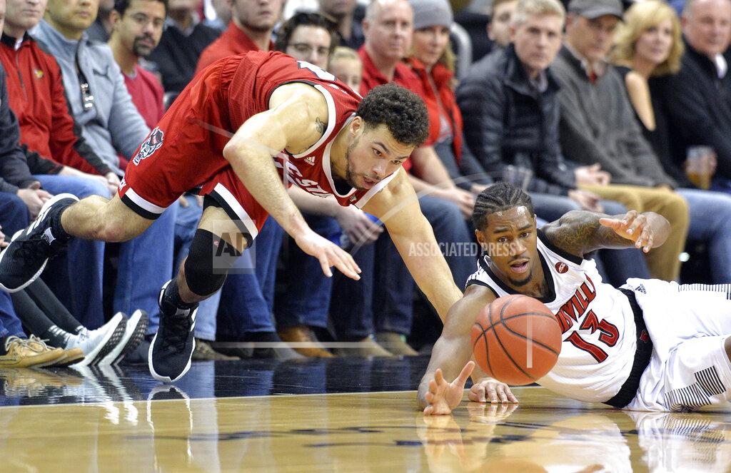 Timothy D. Easley North Carolina State guard Devon Daniels, left, and Louisville forward V.J. King (13) watch the ball bound away during the first half of an NCAA college basketball game in Louisville, Ky., Thursday, Jan. 24, 2019. (AP Photo/Timothy D. Easley)