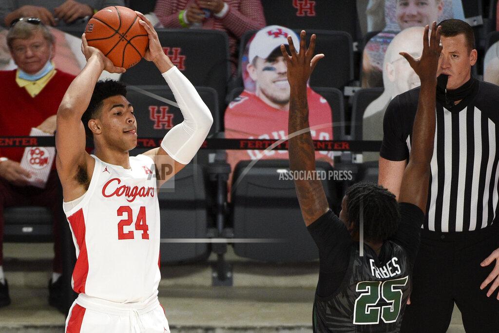 Eric Christian Smith Houston guard Quentin Grimes (24) looks to pass as Tulane guard Jaylen Forbes (25) defends during the first half of an NCAA college basketball game, Saturday, Jan. 9, 2021, in Houston. (AP Photo/Eric Christian Smith)