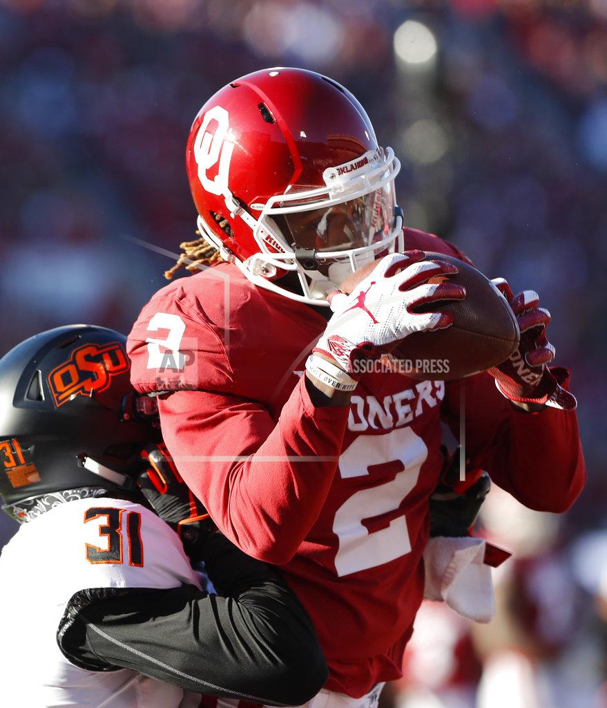 Alonzo Adams Oklahoma wide receiver CeeDee Lamb (2) makes a catch for a touchdown ahead of Oklahoma State safety Kolby Peel (31) that was called back in the first half of an NCAA college football game in Norman, Okla., Saturday, Nov. 10, 2018. (AP Photo/Alonzo Adams)