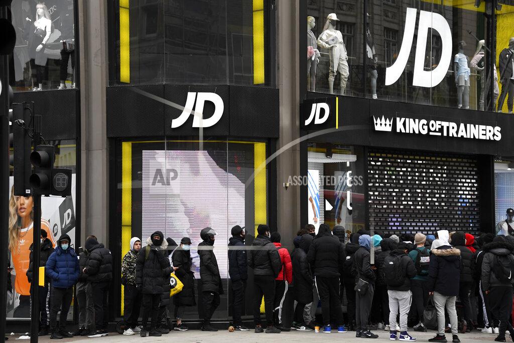 Alberto Pezzali People queue outside a trainers shop waiting for it to open at Oxford Street in London, early Monday morning, April 12, 2021. Millions of people in England will get their first chance in months for haircuts, casual shopping and restaurant meals on Monday, as the government takes the next step on its lockdown-lifting road map. (AP Photo/Alberto Pezzali)