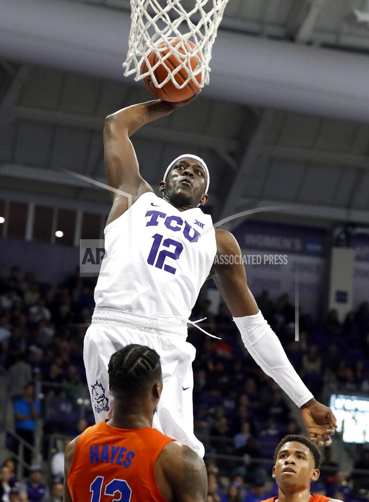 Tony Gutierrez TCU forward Kouat Noi (12), of Australia, goes up to attempt a dunk as Florida center Kevarrius Hayes (13) and Noah Locke, rear, defend in the second half of an NCAA college basketball game in Fort Worth, Texas, Saturday, Jan. 26, 2019. Noi had a game-high 22 points in TCU's 55-50 win. (AP Photo/Tony Gutierrez)