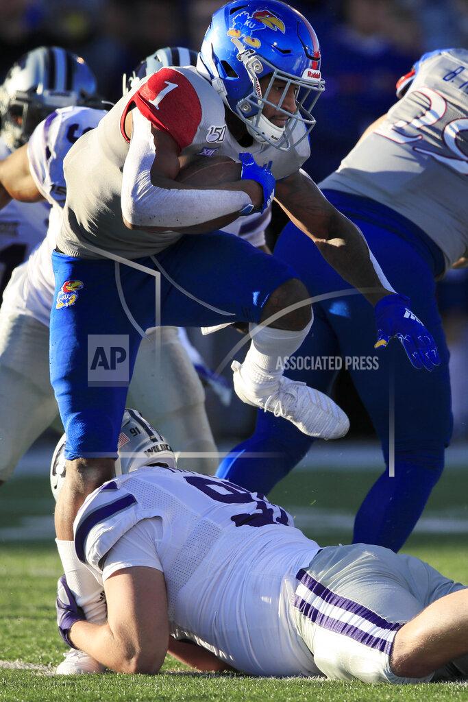 Orlin Wagner Kansas running back Pooka Williams Jr. (1) tries to step over Kansas State defensive tackle Jordan Mittie (91) during the second half of an NCAA college football game in Lawrence, Kan., Saturday, Nov. 2, 2019. Kansas State defeated Kansas 38-10. (AP Photo/Orlin Wagner)