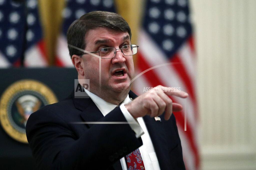 Veterans Affairs Secretary Robert Wilkie talks before President Donald Trump arrives to speak about protecting seniors, in the East Room of the White House, Thursday, April 30, 2020, in Washington. (AP Photo/Alex Brandon)