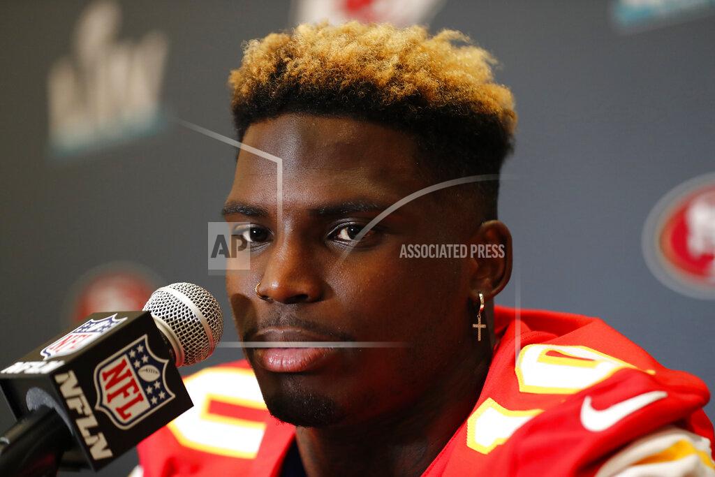 FILE - In this Thursday, Jan. 30, 2020, file photo, Kansas City Chiefs wide receiver Tyreek Hill speaks during a news conference ahead of the NFL Super Bowl 54 football game, in Aventura, Fla. A year ago, Tyreek Hill was a pariah, accused by his fiance of abusing his son. Now, he's a beloved Super Bowl champion raising money to help with the COVID-19 response and handing out free food to front-line workers. (AP Photo/Brynn Anderson, File)