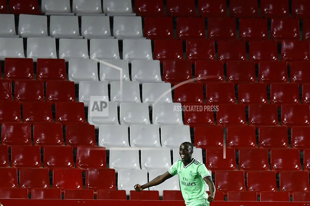 Jose Breton Real Madrid's Ferland Mendy celebrates after scoring the opening goal during the Spanish La Liga soccer match between Granada and Real Madrid at the Los Carmenes stadium in Granada, Spain, Monday, July 13, 2020. (AP Photo/Jose Breton)