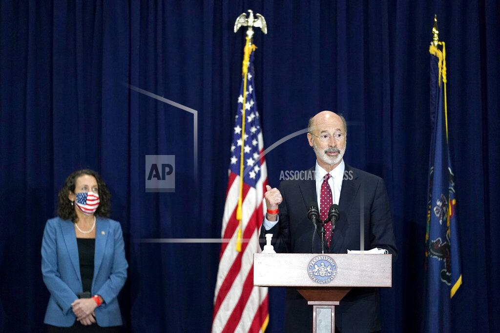 Pennsylvania Gov. Tom Wolf, right, speaks as Pennsylvania Secretary of State Kathy Boockvar, left, looks on during a news conference offering updates regarding the counting of ballots in the 2020 general election, Wednesday, Nov. 4, 2020, in Harrisburg, Pa. (AP Photo/Julio Cortez)