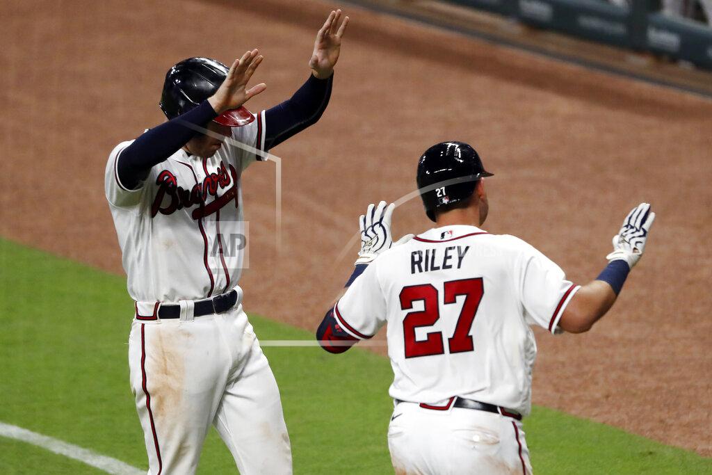 John Bazemore Atlanta Braves' Austin Riley (27) celebrates with teammate Freddie Freeman without contact after hitting a three-run home run in the fifth inning of a baseball game against the Toronto Blue JaysTuesday, Aug. 4, 2020, in Atlanta. (AP Photo/John Bazemore)