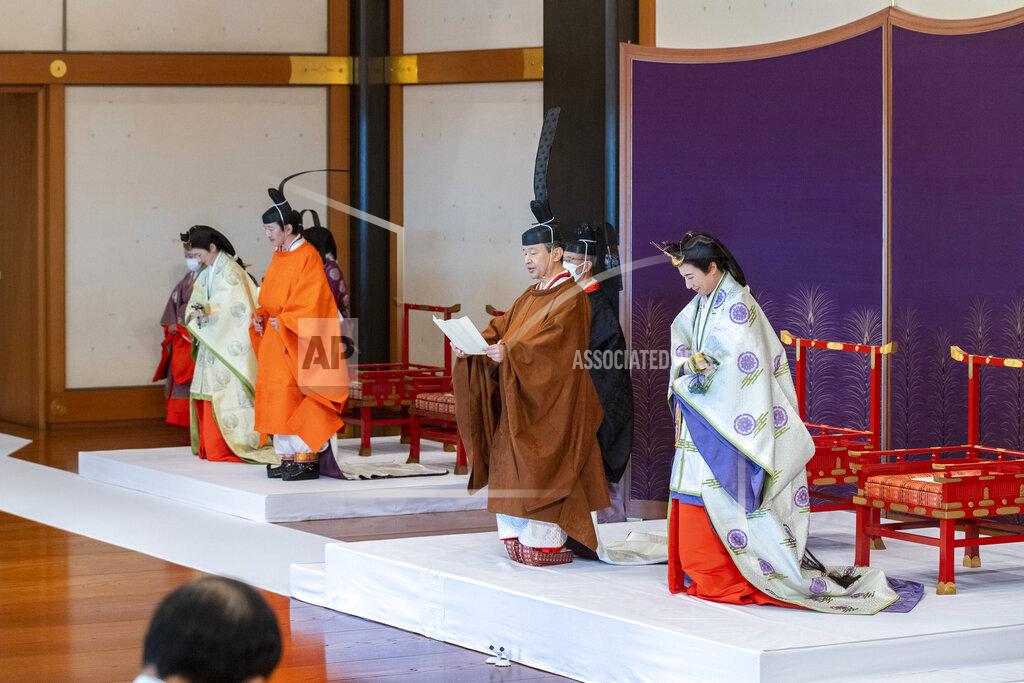 Handout In this photo provided by the Imperial Household Agency of Japan, Japan's Crown Prince Akishino, in orange robe, flanked by his wife Crown Princess Kiko, second from left, attends a ceremony for formally proclaims Akishino is the first in line to the Chrysanthemum Throne, with Emperor Naruhito, second from right, and Empress Masako, right, at the Imperial Palace in Tokyo, Sunday, Nov. 8, 2020. Akishisho, Naruhito's younger brother, was formally sworn in as first in line to the Chrysanthemum Throne in a traditional palace ritual that has been postponed for seven month and scaled down due to the coronavirus pandemic. (Imperial Household Agency of Japan via AP)