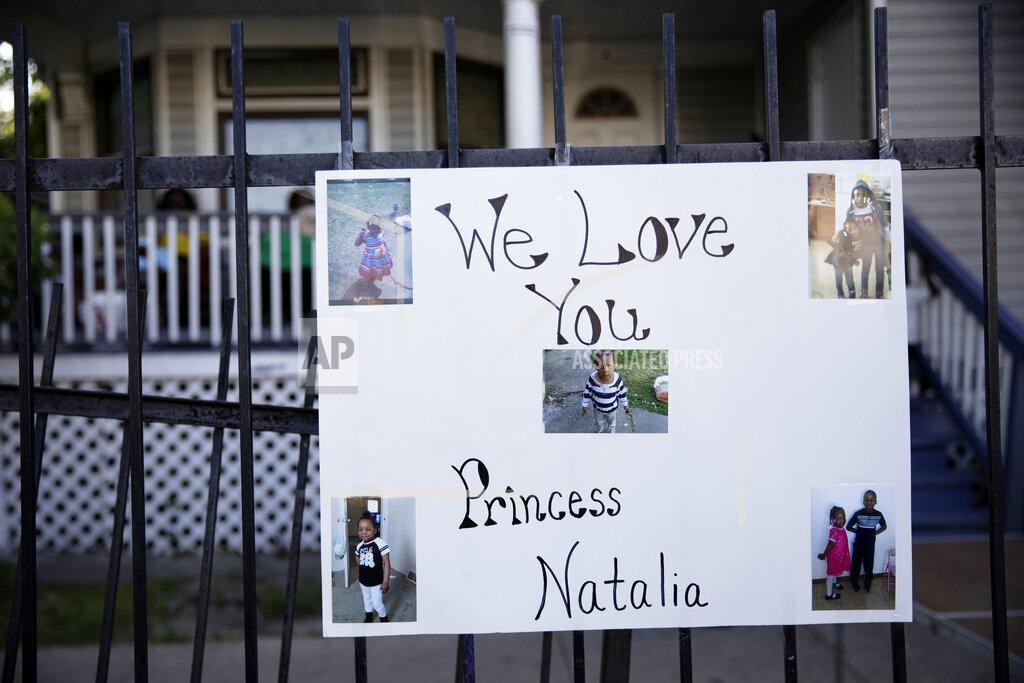 A poster with photos are attached to a fence in the South Austin neighborhood of Chicago on Sunday, July 5, 2020, during a vigil for 7-year-old Natalie Wallace, who was shot and killed as her family gathered to celebrate the Fourth of July holiday Saturday night in the 100 bock of North Latrobe Avenue Kingsbury Street. (Erin Hooley/Chicago Tribune via AP)