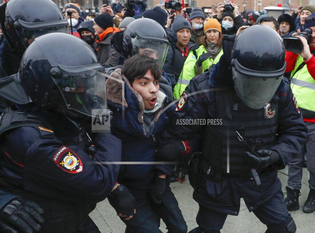 Pavel Golovkin Police detain a man during a protest against the jailing of opposition leader Alexei Navalny in Moscow, Russia, Saturday, Jan. 23, 2021. Russian police are arresting protesters demanding the release of top Russian opposition leader Alexei Navalny at demonstrations in the country's east and larger unsanctioned rallies are expected later Saturday in Moscow and other major cities. (AP Photo/Pavel Golovkin)