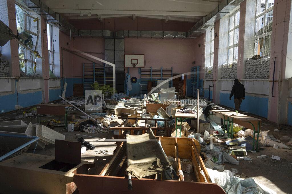 Evgeniy Maloletka A man walks through the sports gym in the school which was used as a Russian military hospital in the recently retaken area of Izium, Ukraine, Wednesday, Sept. 21, 2022. (AP Photo/Evgeniy Maloletka)