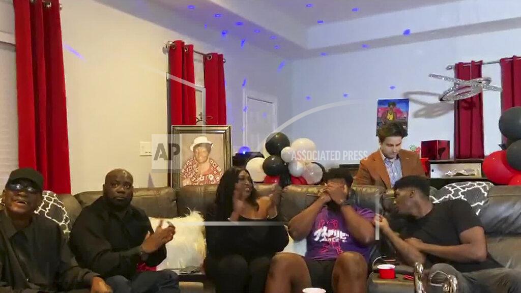 Uncredited In this still image from video provided by the NFL, Josh Jones puts his hands to his face as he is selected by the Arizona Cardinals during the third round of the NFL football draft, Friday, April 24, 2020. (NFL via AP)