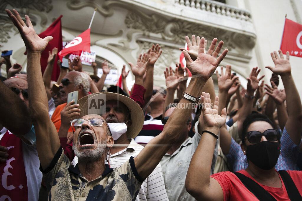 Riadh Dridi Demonstrators gesture during a protest against Tunisian President Kais Saied, Saturday, Sept. 18, 2021 in Tunis. In July Tunisian President Kais Saied fired the country's prime minister and froze parliament's activities after violent demonstrations over the country's pandemic and economic situation. The movement made by Saied was considered by his opponents as a coup. (AP Photo/Riadh Dridi)