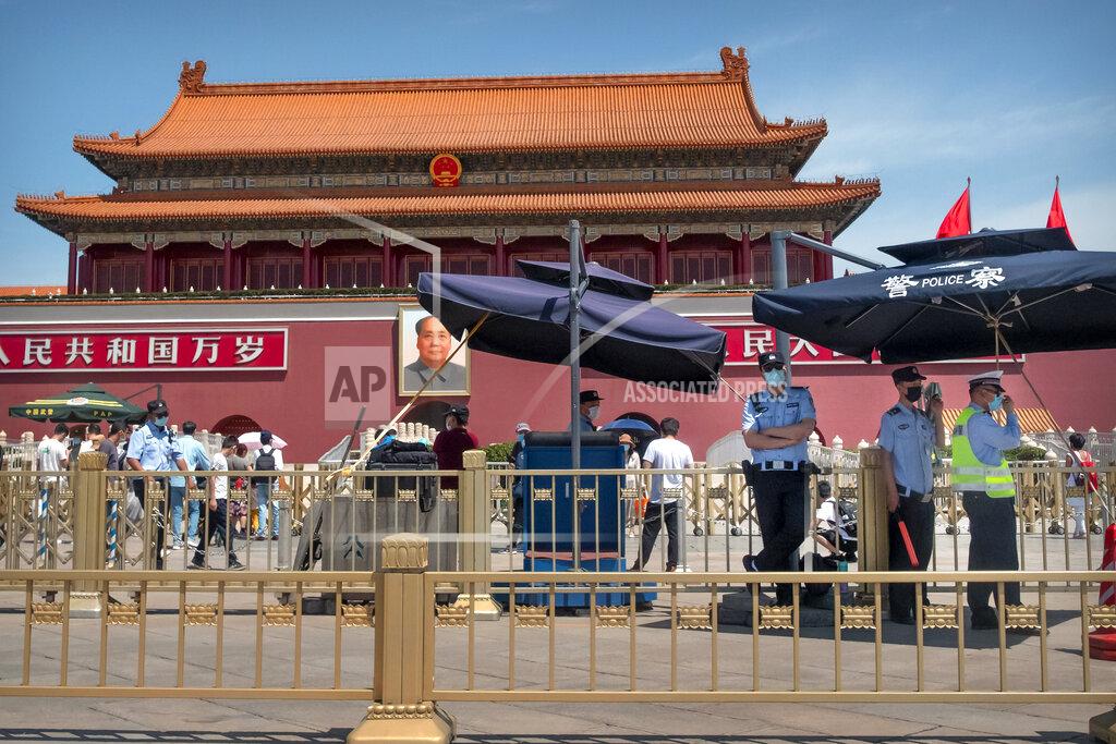 Mark Schiefelbein In this Wednesday, May 20, 2020, photo, Chinese police stand guard in front of Tiananmen Gate in Beijing. This year's version of China's biggest political meeting of the year will be unlike any other. Delayed from March because of the then-spiraling coronavirus outbreak, the decision to go ahead with the gathering signals a partial return to normalcy in the country where the pandemic first broke out. "Partial" being the operative word: The congress will be far from normal. (AP Photo/Mark Schiefelbein)