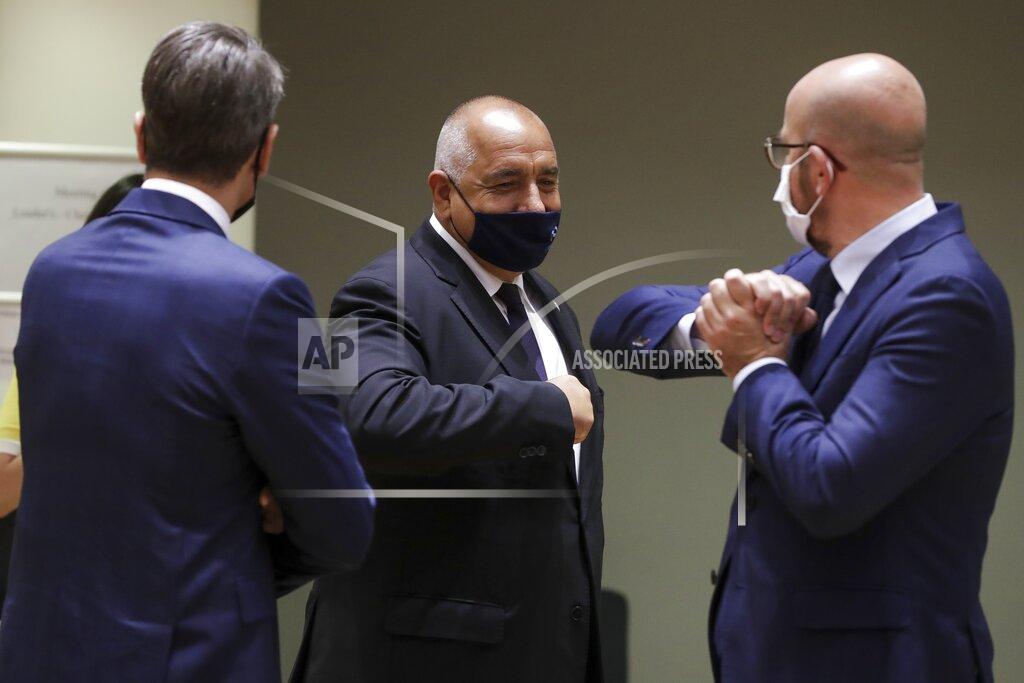 Stephanie Lecocq European Council President Charles Michel, right, greets Bulgaria's Prime Minister Boyko Borissov, center, with an elbow bump during a round table meeting at an EU summit in Brussels, Friday, July 17, 2020. Leaders from 27 European Union nations meet face-to-face on Friday for the first time since February, despite the dangers of the coronavirus pandemic, to assess an overall budget and recovery package spread over seven years estimated at some 1.75 trillion to 1.85 trillion euros. (Stephanie Lecocq, Pool Photo via AP)