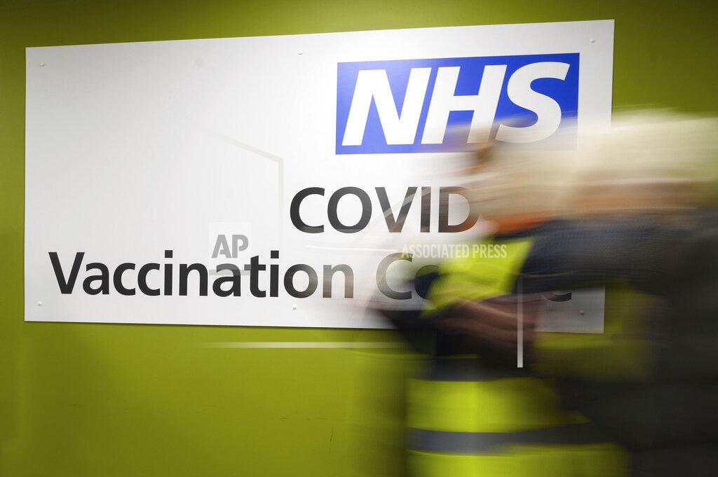 FILE - In this Thursday, Jan. 14, 2021 file photo, a sign in the interior of the NHS vaccination centre in Robertson House, Stevenage, England. An Italian man living in Berlin has on Friday Feb. 26, 2021 been convicted of attempted extortion for threatening to blow up a British National Health Service hospital unless he was paid off with 10 million pounds ($13.2 million) in crypto currency. Defendant Emil A., whose last name wasn’t given in line with German privacy laws, was sentenced to three years in prison.(Leon Neal/Pool Photo via AP, file)