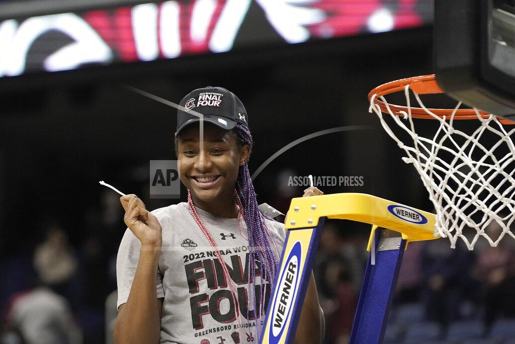 Gerry Broome FILE - South Carolina forward Aliyah Boston (4) reacts after cutting the net following a college basketball game against Creighton in the Elite 8 round of the NCAA tournament in Greensboro, N.C., Sunday, March 27, 2022. Boston is a unanimous choice to the women's Associated Press preseason All-America team, Tuesday, Oct. 25, 2022. (AP Photo/Gerry Broome, File)