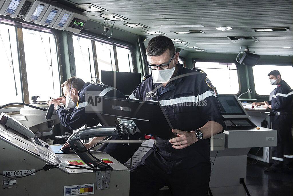 Y. Bisson This photo provided Saturday April 10, 2020 by the French Navy (Marine Nationale) shows sailors wearing face masks aboard the French aircraft carrier Charles de Gaulle, Thursday April 8, 2020 in the Atlantic Ocean. France's only aircraft carrier has confirmed 50 cases of the new virus aboard and is heading back to port. Three of those aboard the Charles de Gaulle with the virus have been flown to French hospitals for treatment, the French military said in a statement Friday .The new coronavirus causes mild or moderate symptoms for most people, but for some, especially older adults and people with existing health problems, it can cause more severe illness or death. (Y. Bisson/Marine Nationale via AP)