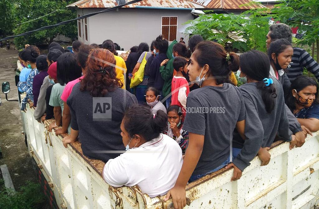 Rofinus Monteiro Women and children travel by truck to a temporary shelter for those affected by flooding in Ile Boleng on Adonara Island, East Nusa Tenggara province, Indonesia, Wednesday, April 7, 2021. Multiple disasters triggered by Tropical Cyclone Seroja in eastern Indonesia and neighboring East Timor have left a number of people dead or missing. (AP Photo/Rofinus Monteiro)