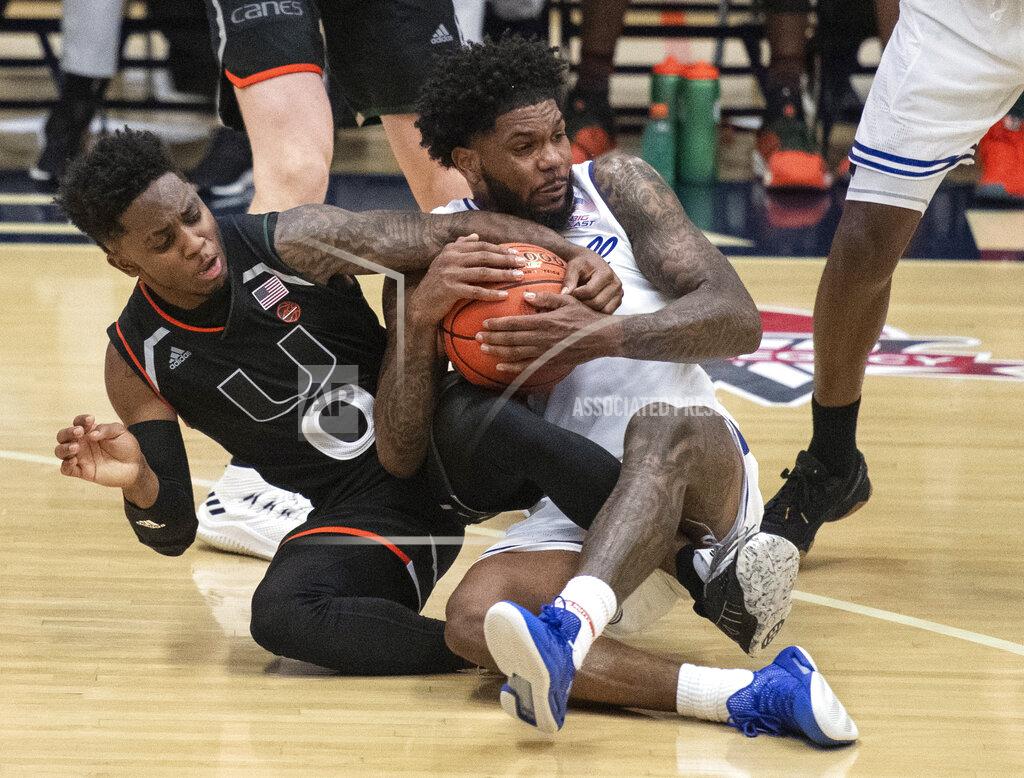 Kyusung Gong FILE - In this Sunday, Nov. 25, 2018, file photo, Miami guard Chris Lykes, left, and Seton Hall guard Myles Powell fight for a loose ball during the second half of an NCAA college basketball final game at the Wooden Legacy tournament in Fullerton, Calif. Lykes, the Miami Hurricanes’ 5-foot-7 dynamo, has become one of the leading scorers in the Atlantic Coast Conference. (AP Photo/Kyusung Gong, File)