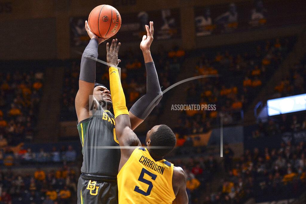 William Wotring Baylor forward Flo Thamba (0) shoots while being guarded by West Virginia forward Dimon Carrigan (5) during the second half of an NCAA college basketball game in Morgantown, W.Va., Tuesday, Jan. 18, 2022. (William Wotring)