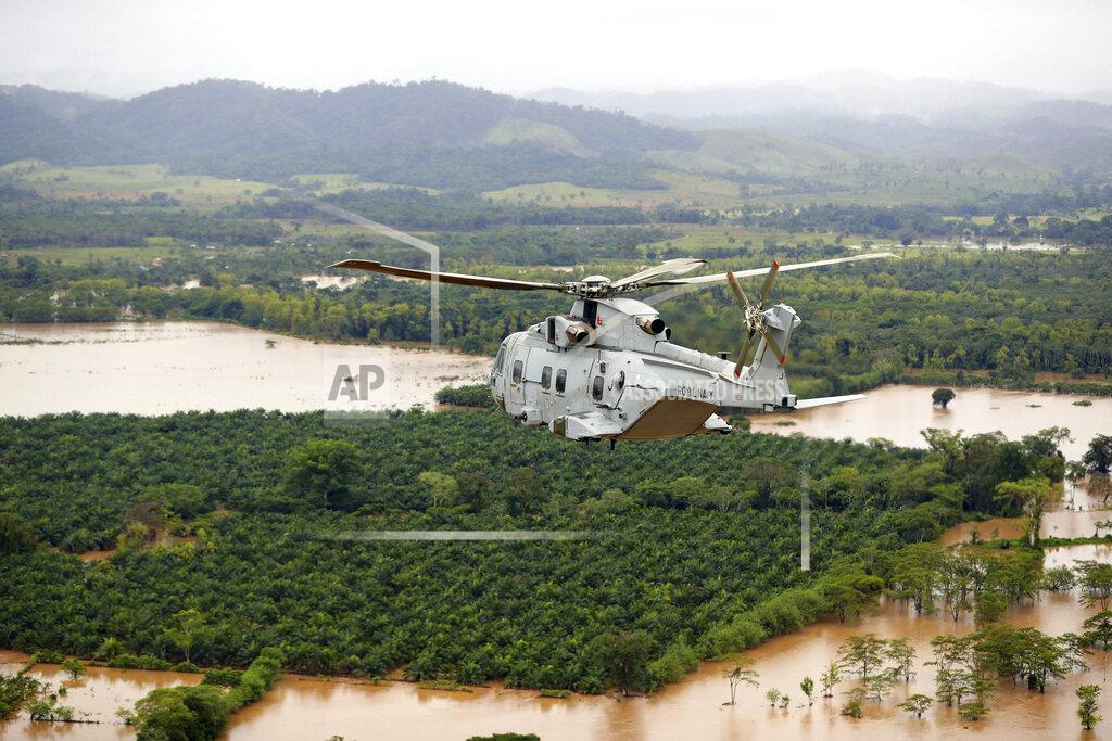 Lphot Robert Oates In this undated handout photo provided by the Ministry of Defence on Saturday, Nov. 21, 2020, a Merlin Helicopter from 845 Naval Air Squadron conducting damage surveys in Honduras. The devastation caused by Hurricane Iota is becoming clear as communications are restored after the second Category 4 hurricane in two weeks to blast Nicaragua’s Caribbean coast. The official death toll rose in Nicaragua with victims swept away by swollen rivers or buried in landslides. (LPhot Robert Oates/Ministry of Defence via AP)