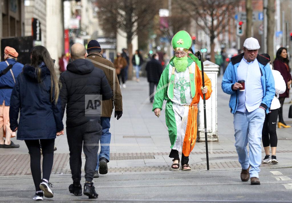 Peter Morrison A man dressed as St Patrick walks down O'Connell street in Dublin, Ireland, Wednesday, March, 17, 2021. The St Patrick's Day parades across Ireland were canceled for the second year due to COVID-19 pandemic. (AP Photo/Peter Morrison)